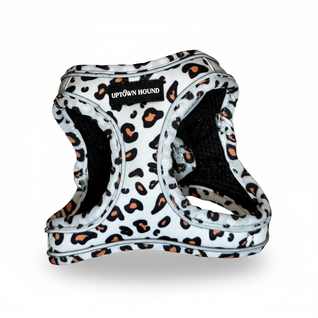 Leopard print dog harness with 'Uptown Hound' label on a light gray background