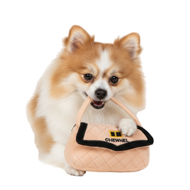 Dog playing with Chewnel handbag toy